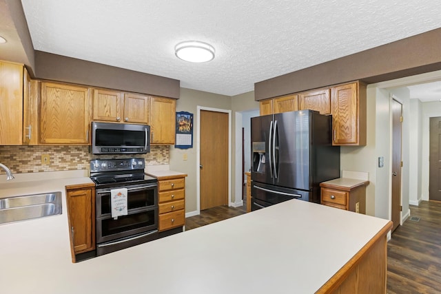 1616 Saddlebrook Dr, Heath, OH 43056 - kitchen featuring backsplash, appliances with stainless steel finishes, dark wood finished floors, a sink, and light countertops