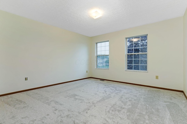 1616 Saddlebrook Dr, Heath, OH 43056 - spare room with carpet floors, a textured ceiling, baseboards, and visible vents