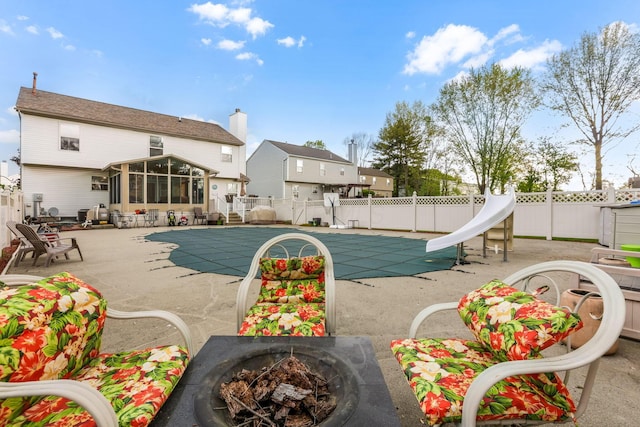 1616 Saddlebrook Dr, Heath, OH 43056 - view of pool with a fenced backyard, a sunroom, a fenced in pool, an outdoor fire pit, and a water slide