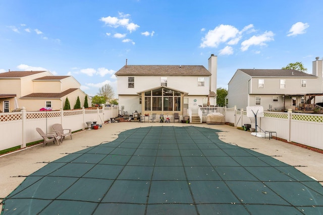 1616 Saddlebrook Dr, Heath, OH 43056 - rear view of property featuring a sunroom, a fenced backyard, a fenced in pool, and a patio