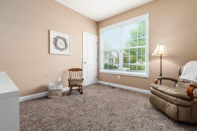 sitting room with carpet flooring and baseboards