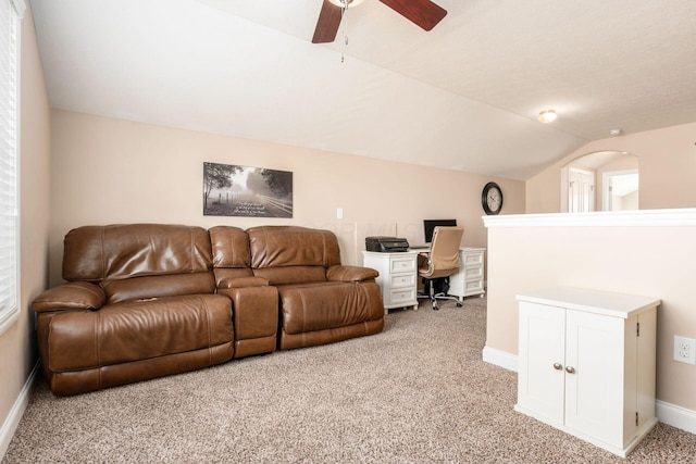 living area with baseboards, ceiling fan, lofted ceiling, and carpet