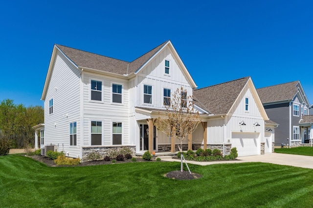 view of front of property with driveway, board and batten siding, and a front lawn