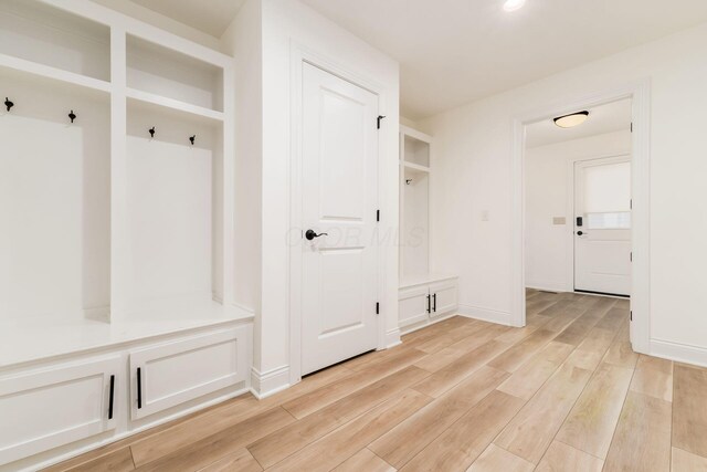mudroom featuring baseboards and light wood-style floors