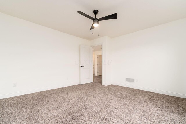 empty room featuring baseboards, visible vents, ceiling fan, and carpet floors
