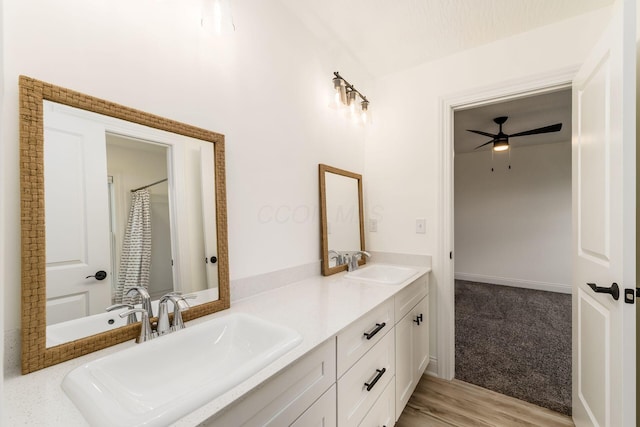 full bath with double vanity, a sink, and ceiling fan