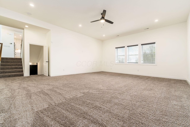 carpeted empty room with recessed lighting, ceiling fan, stairway, and baseboards