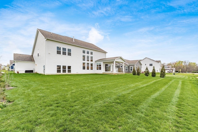 back of property with a lawn