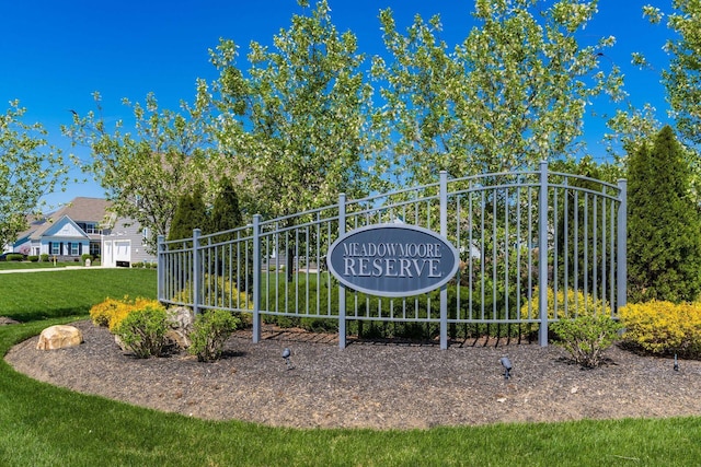 community sign featuring a lawn