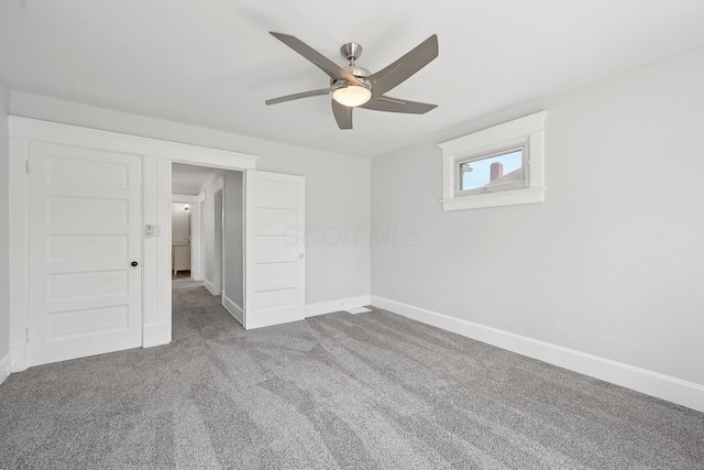 unfurnished bedroom with baseboards, ceiling fan, and carpet floors