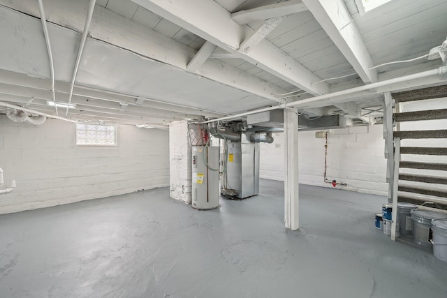 basement featuring heating unit, electric water heater, and stairs