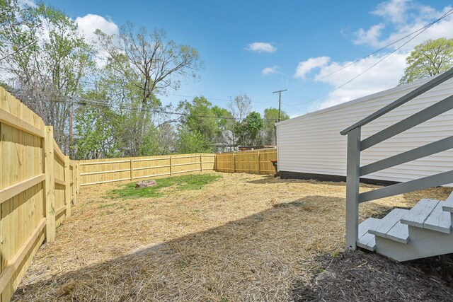 view of yard with a fenced backyard