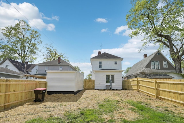back of property featuring a fenced backyard