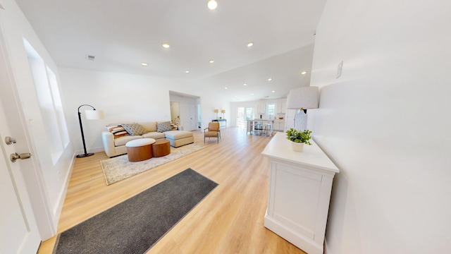 living area featuring light wood-type flooring, visible vents, and recessed lighting