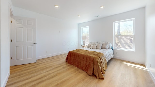 bedroom with recessed lighting, light wood-type flooring, visible vents, and baseboards