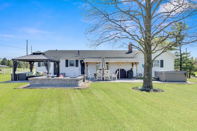 757 State Rte 61, Sunbury, OH 43074 - back of property featuring a patio, a gazebo, a chimney, and a hot tub