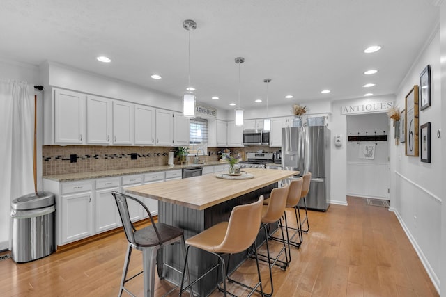 757 State Rte 61, Sunbury, OH 43074 - kitchen with recessed lighting, butcher block countertops, white cabinetry, and stainless steel appliances