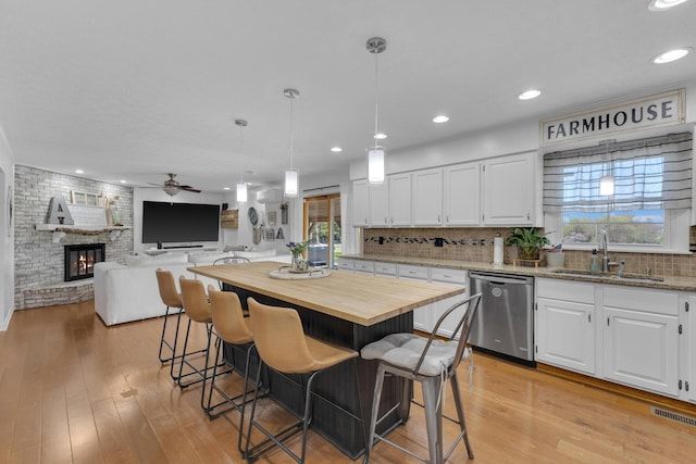 757 State Rte 61, Sunbury, OH 43074 - kitchen featuring white cabinets, wooden counters, ceiling fan, dishwasher, and a sink