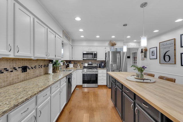 757 State Rte 61, Sunbury, OH 43074 - kitchen featuring recessed lighting, a sink, butcher block countertops, stainless steel appliances, and white cabinetry