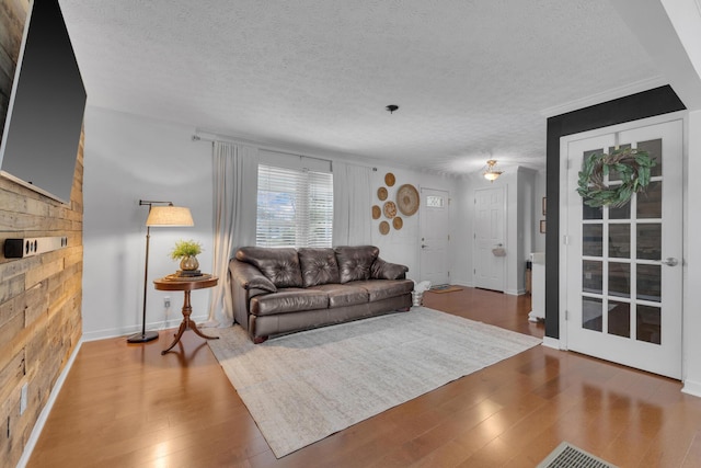 757 State Rte 61, Sunbury, OH 43074 - living area with wooden walls, a textured ceiling, wood finished floors, and baseboards