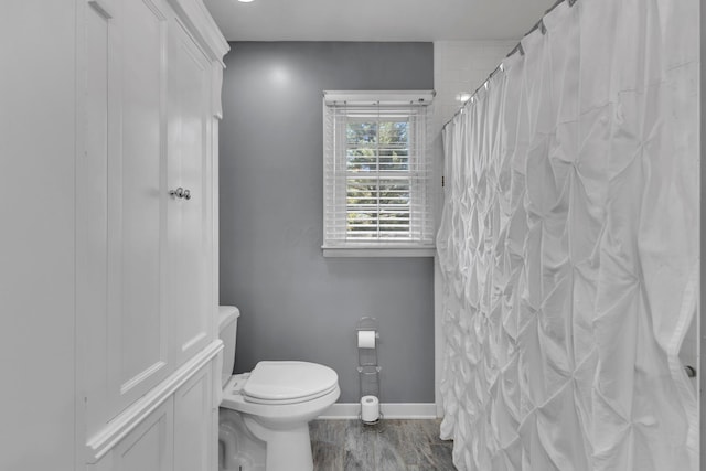 757 State Rte 61, Sunbury, OH 43074 - full bathroom with wood finished floors, toilet, a shower with shower curtain, and baseboards