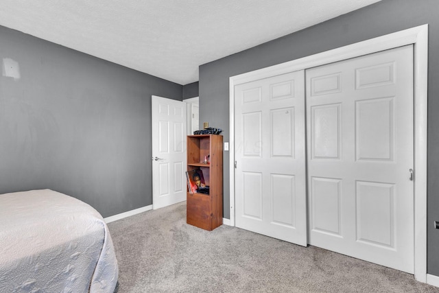 757 State Rte 61, Sunbury, OH 43074 - bedroom featuring a closet, a textured ceiling, carpet floors, and baseboards