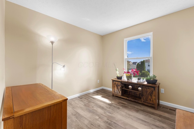 office area featuring baseboards and wood finished floors