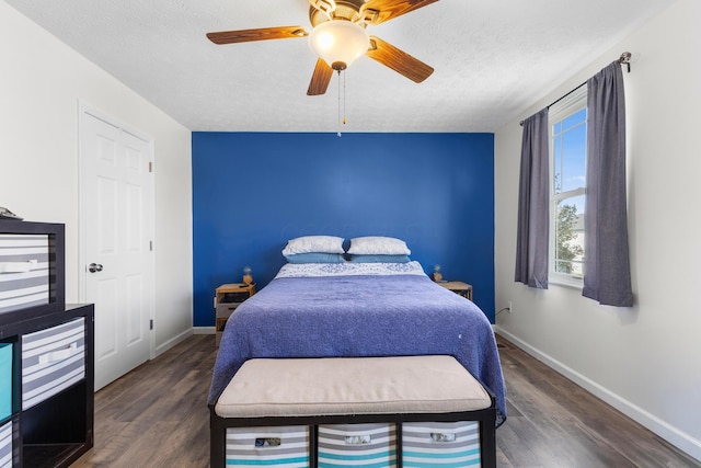 bedroom featuring baseboards, wood finished floors, and multiple windows