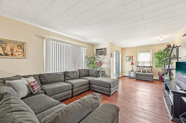 8870 College St, Lakeview, OH 43331 - living area featuring baseboard heating, wood finished floors, and an AC wall unit