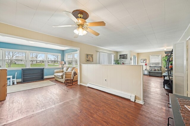 8870 College St, Lakeview, OH 43331 - living area with baseboards, a ceiling fan, dark wood-style floors, and a baseboard radiator