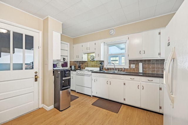 8870 College St, Lakeview, OH 43331 - kitchen featuring dark countertops, crown molding, a sink, light wood-style floors, and white appliances
