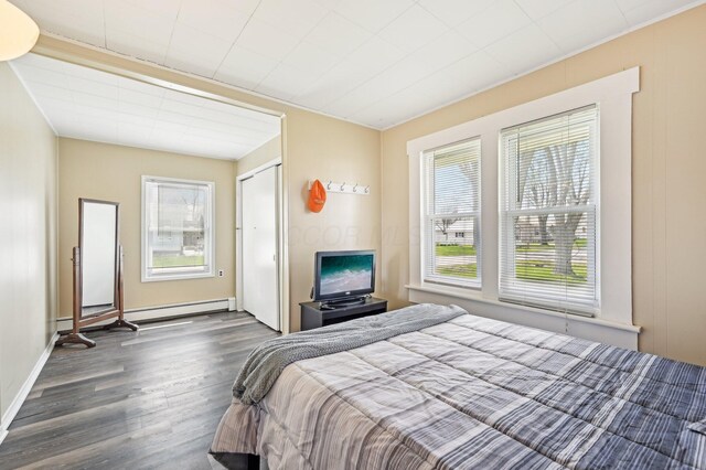 8870 College St, Lakeview, OH 43331 - bedroom featuring dark wood finished floors, a closet, and baseboard heating