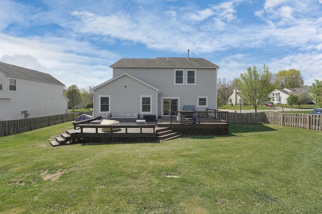 back of house featuring a wooden deck, a fenced backyard, and a yard
