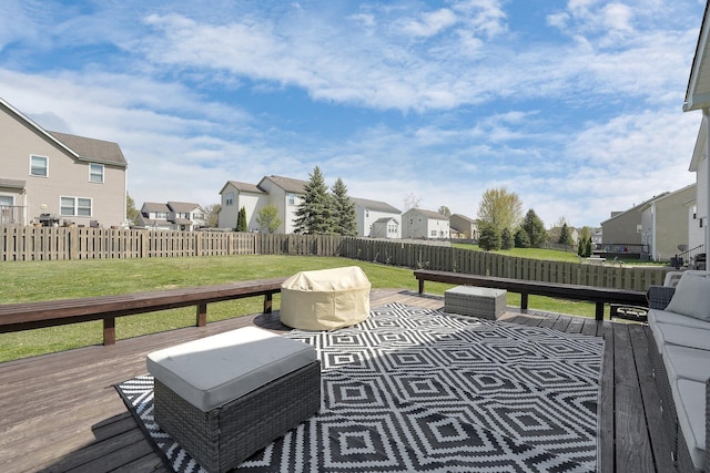 wooden deck with a yard, a residential view, and a fenced backyard