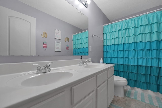 full bath with toilet, tile patterned flooring, a sink, and double vanity