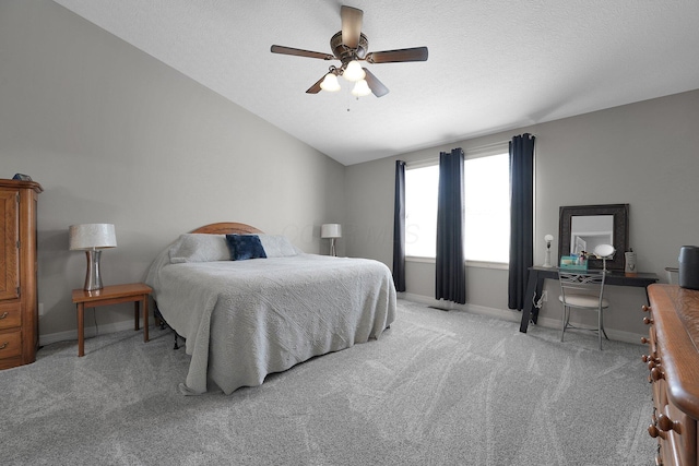 carpeted bedroom with vaulted ceiling, a ceiling fan, and baseboards