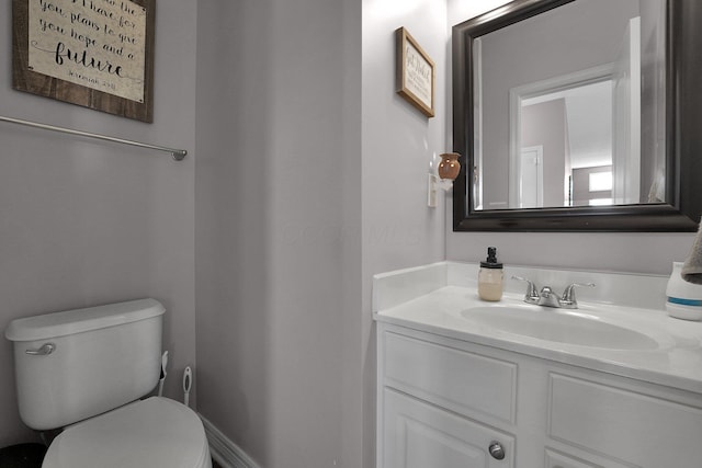 bathroom featuring toilet and vanity