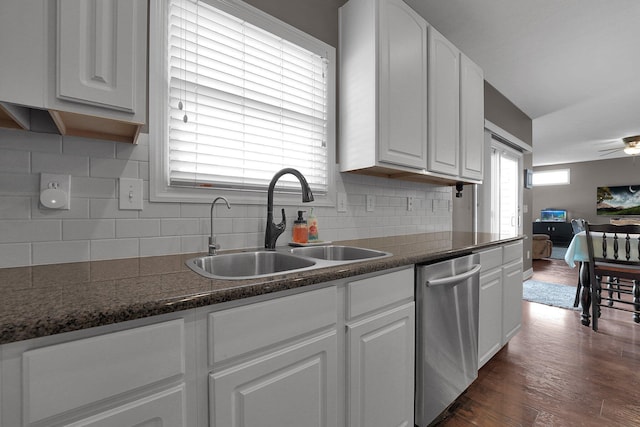 kitchen with white cabinets, decorative backsplash, dishwasher, and a sink