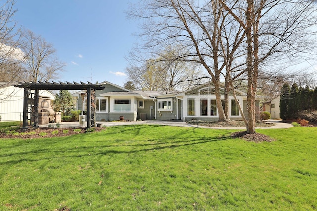 rear view of house with a yard, a pergola, and a patio area