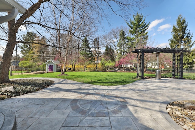 view of home's community featuring an outdoor structure, fence, a pergola, a patio, and a yard