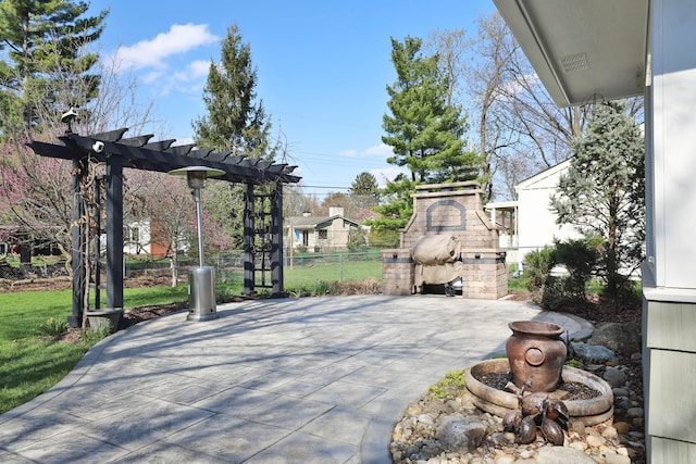 view of patio featuring fence, a pergola, and an outdoor stone fireplace