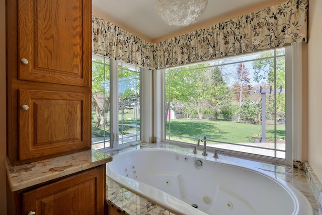 full bathroom featuring a healthy amount of sunlight and a jetted tub