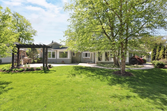 rear view of property with a pergola, a yard, and a patio