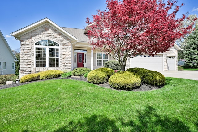 view of front facade featuring concrete driveway, an attached garage, a front lawn, and stone siding