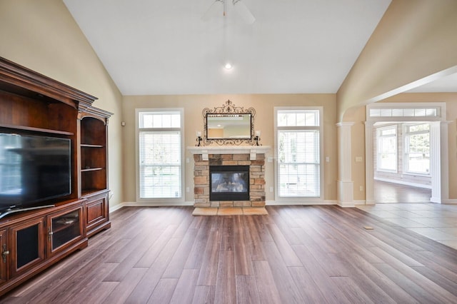 unfurnished living room with ceiling fan, wood finished floors, and plenty of natural light