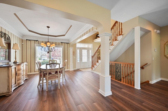 dining space featuring an inviting chandelier, dark wood-style flooring, baseboards, stairway, and a tray ceiling