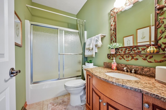 bathroom with enclosed tub / shower combo, tile patterned floors, toilet, and vanity