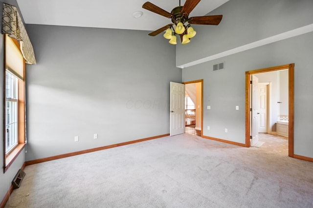 unfurnished bedroom featuring visible vents, carpet flooring, high vaulted ceiling, and baseboards
