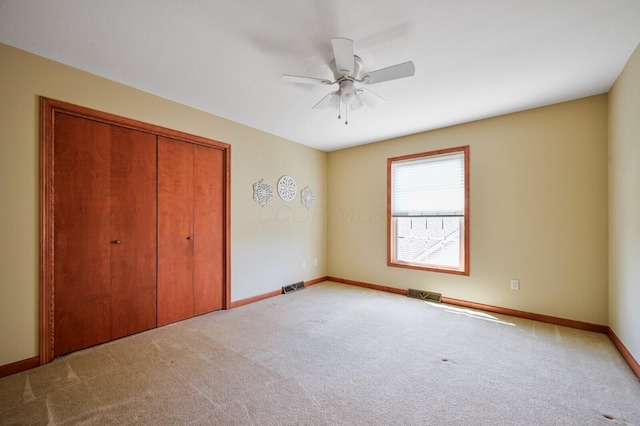 unfurnished bedroom featuring visible vents, a closet, carpet flooring, and baseboards