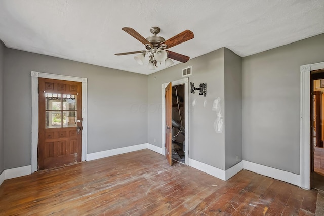 entryway featuring wood-type flooring, ceiling fan, baseboards, and visible vents